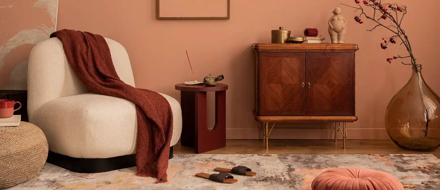   Bright living room with brown leather sofa, beige armchair, yellow throw, and adjacent dining area.